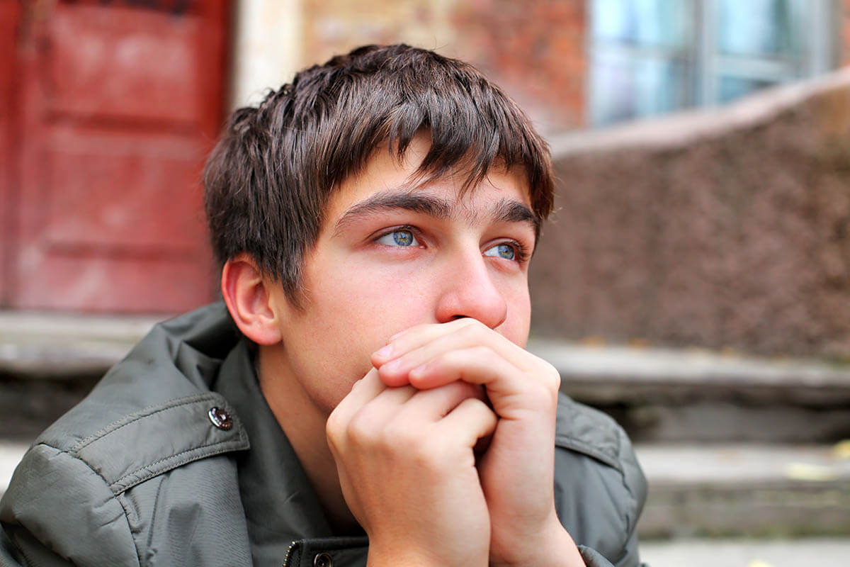 teen sitting outside thinking about marijuana abuse in teens