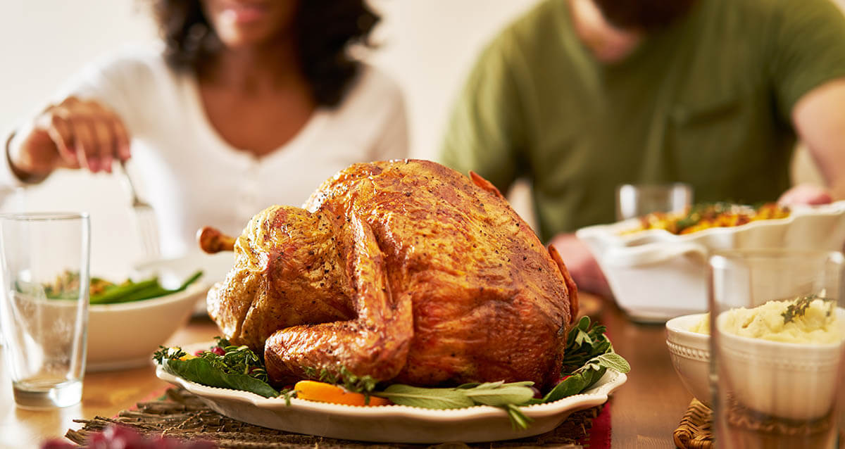 a turkey on a table as people talk about family therapy activities for thanksgiving