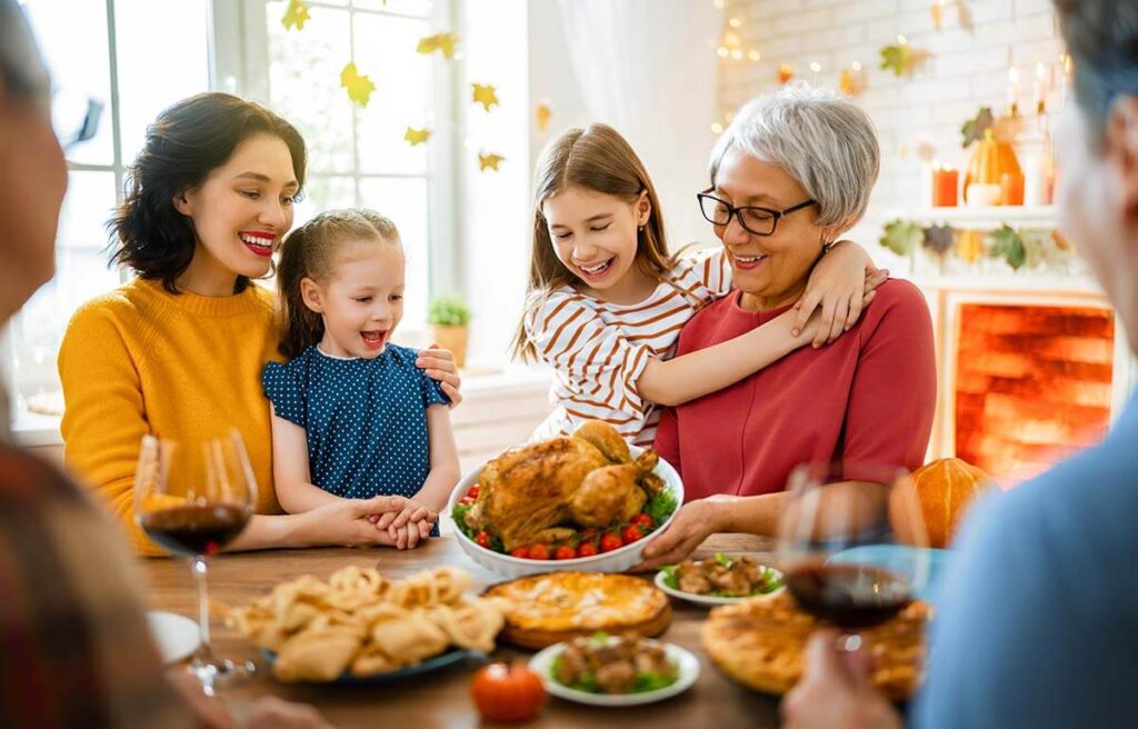 a family gathers around a dinner table, possibly wondering the limit for drinking in moderation