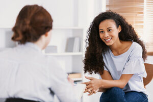 happy person in counseling while participating in a meditation assisted treatment program in virginia