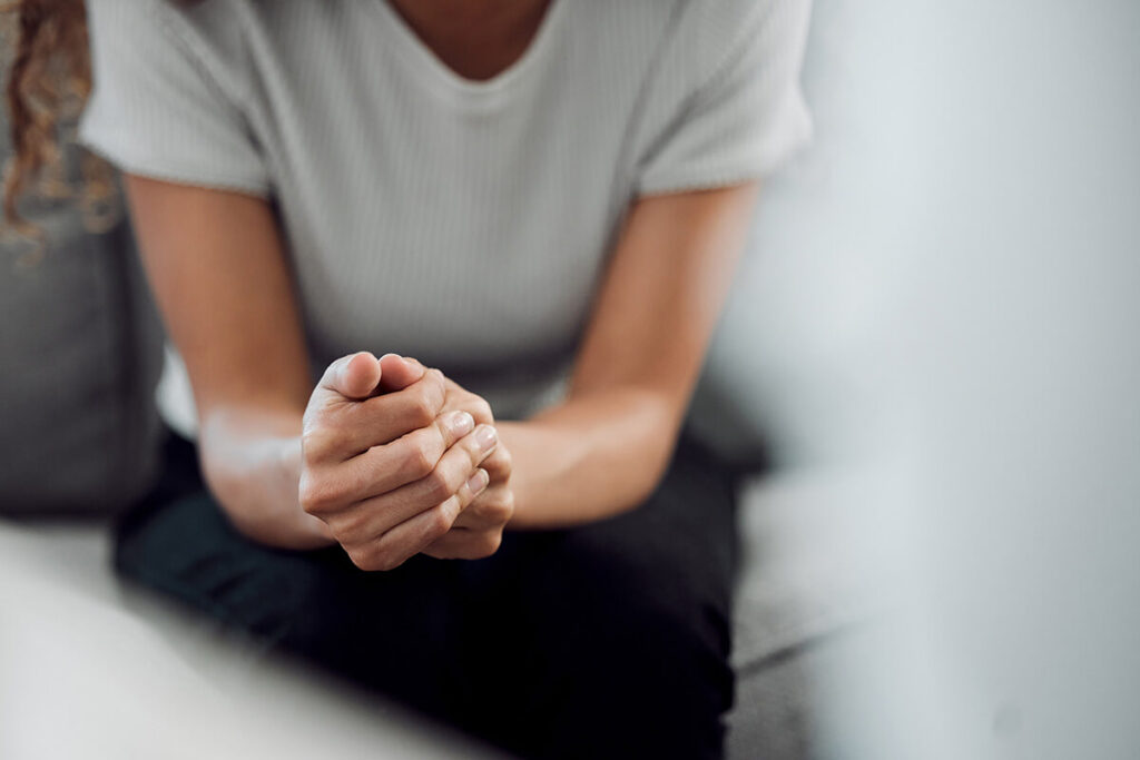 person sitting comfortably with hands folded in counseling at an intensive outpatient program near Broadlands VA
